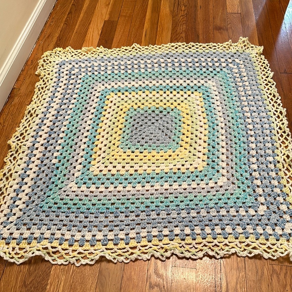 Hand knitted blanket and small baby “shoes”